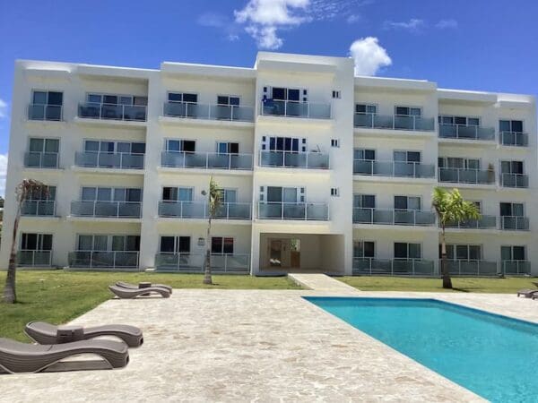 A large building with a pool in front of it