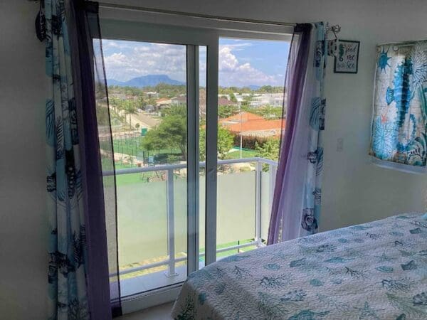 A bedroom with a view of the golf course.