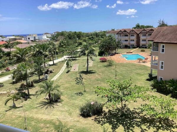 A view of the pool and trees from above.