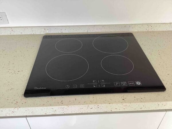 A black stove top sitting on top of a counter.