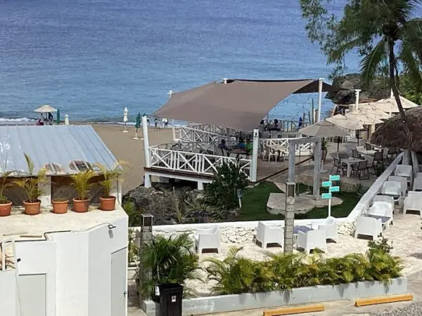 Beachfront dining area with a large canopy, white fencing, and adjacent sandy beach lined with lounge chairs and palm umbrellas. becomes
Ocean Front Lavish *Jr Penthouse* Exquisite Views dining area with a large canopy, white fencing, and adjacent sandy beach lined with lounge chairs and palm umbrellas.