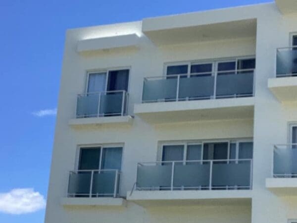 A building with many windows and balconies on the outside.