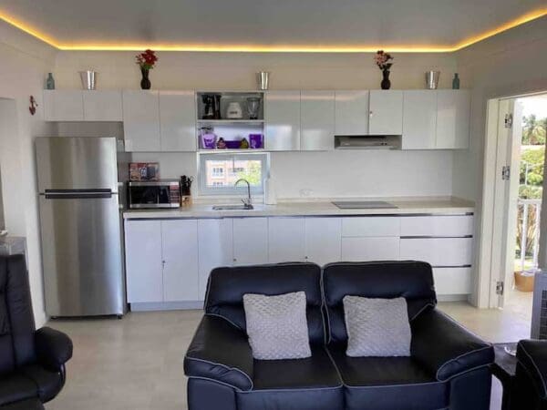 A living room with a couch and a refrigerator