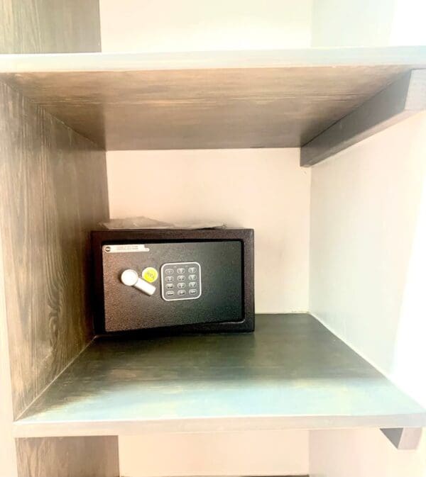 A small black box sitting on top of a shelf.