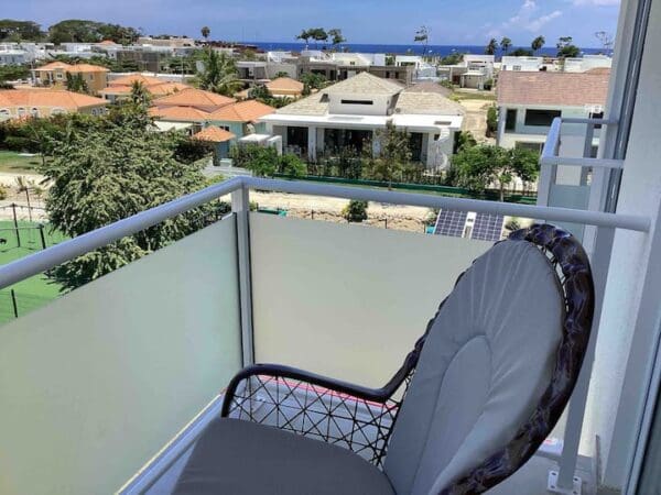 A view of the ocean from an apartment balcony.