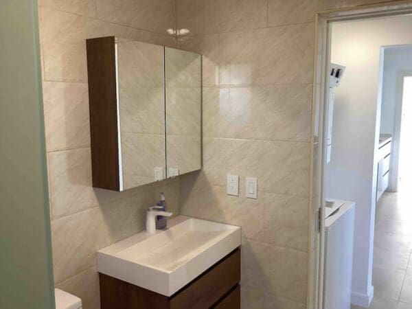 A bathroom with a sink and mirror in it