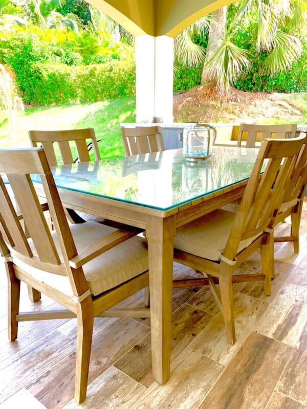 A table with six chairs and a glass top.