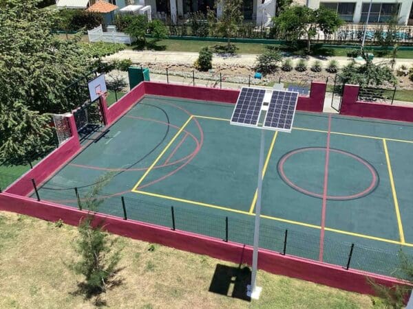 A basketball court with a solar panel on the top of it.