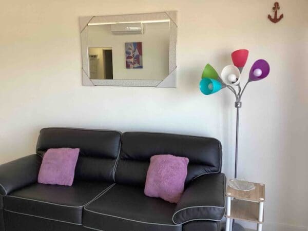 A living room with a couch and a mirror