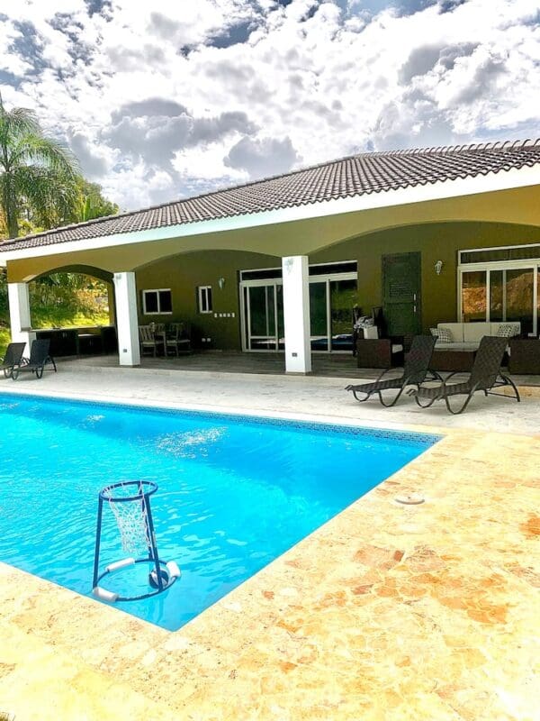 A pool with a swimming area and a large patio.