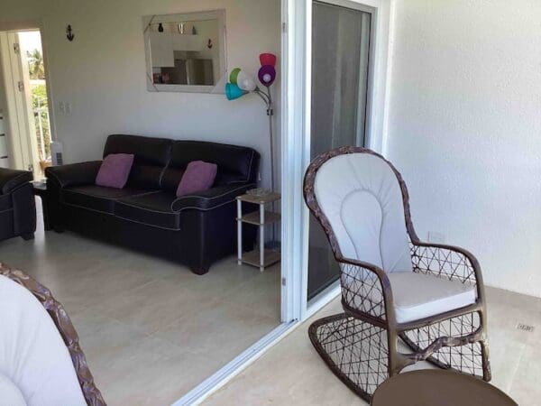 A living room with a couch and rocking chair