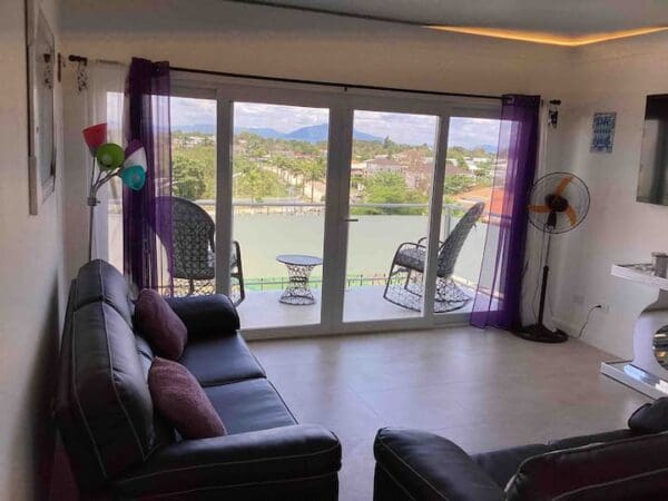 A living room with large windows and a lake view.