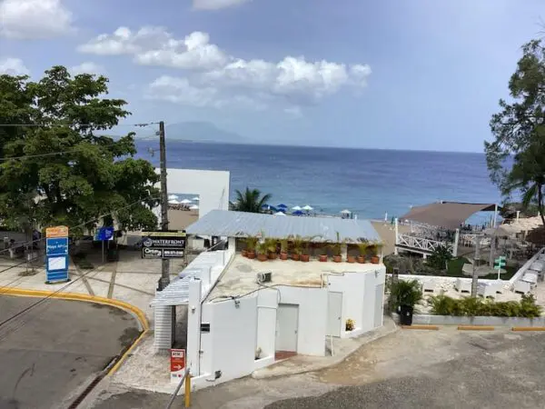 View of Ocean Front Lavish *Jr Penthouse* Exquisite Views with buildings leading to a clear blue sea, under a partly cloudy sky.