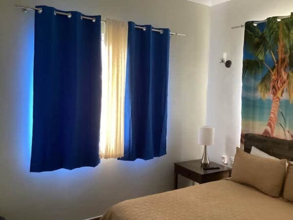 A bedroom with blue curtains and a bed