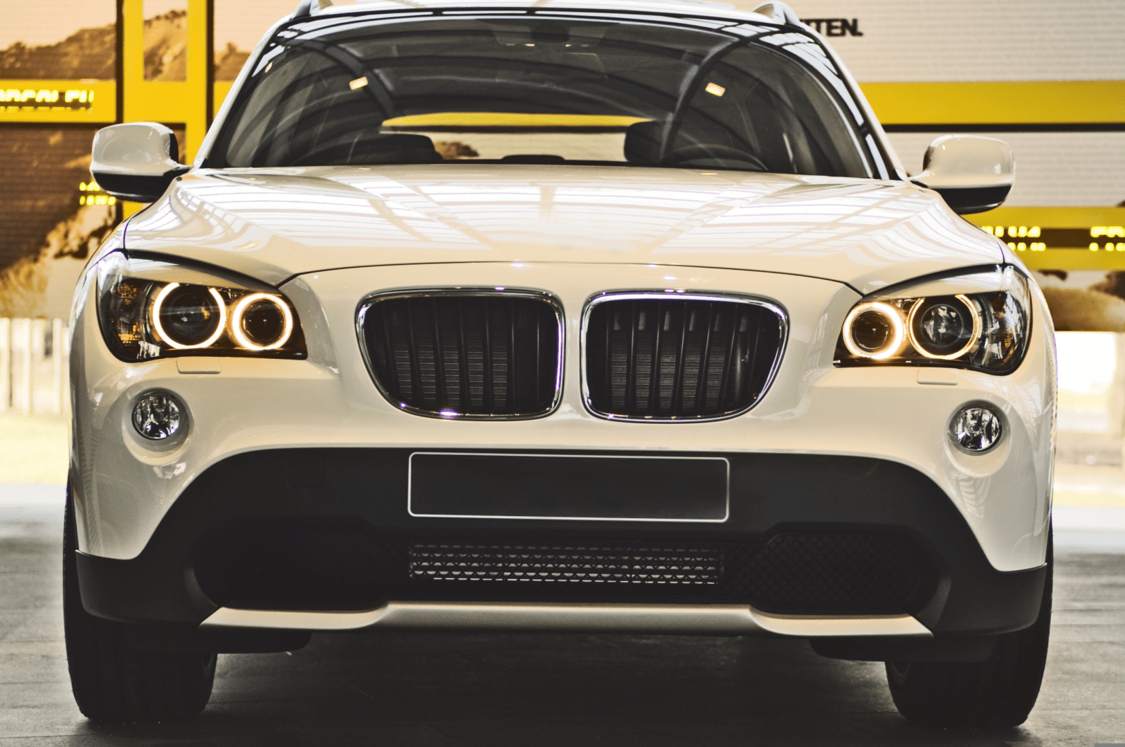 A close up of the front end of a white car